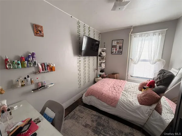 a bedroom with a bed and flat screen tv