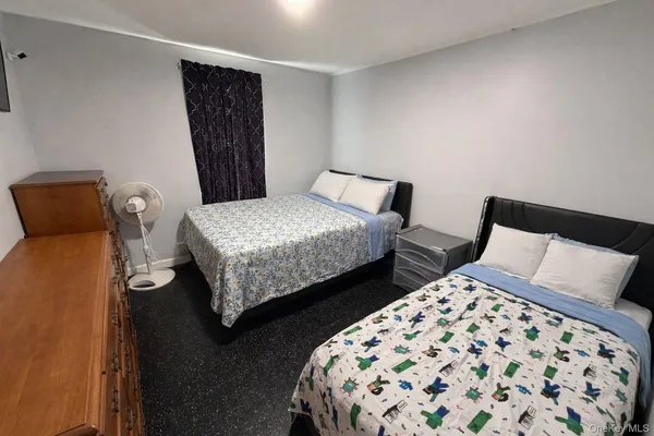 a bedroom with two beds and a lamp