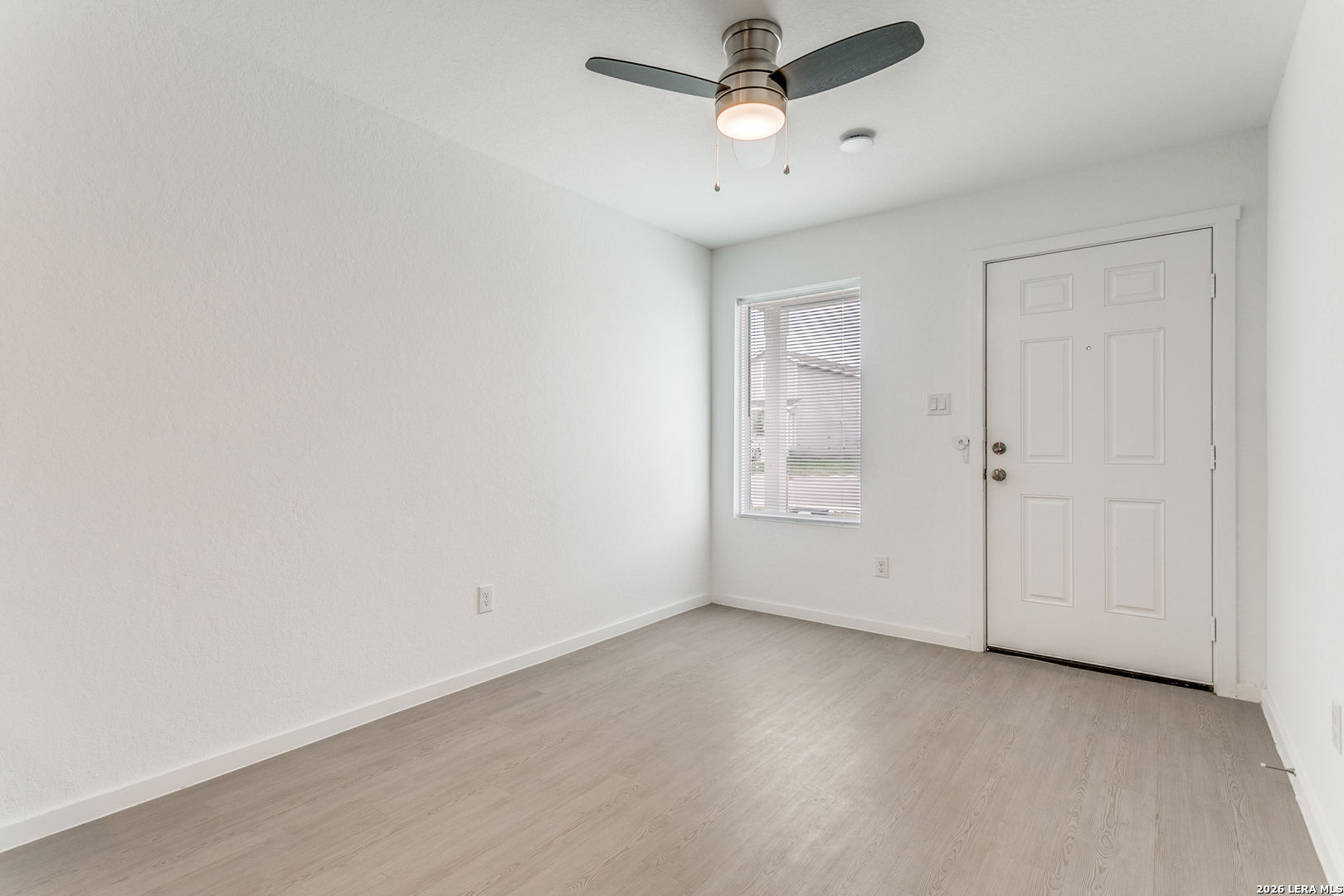 5010 Primrose Converse, TX 78109 - Photo 5 of 24 an empty room with a ceiling fan and wooden floor