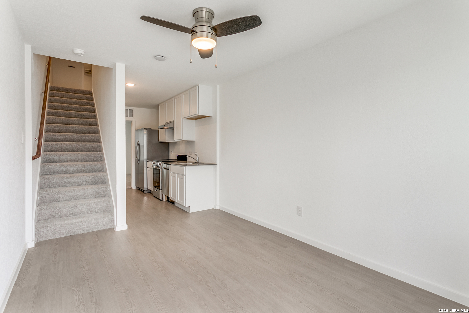 5010 Primrose Converse, TX 78109 - Photo 6 of 24 a view of kitchen and hallway with stairs