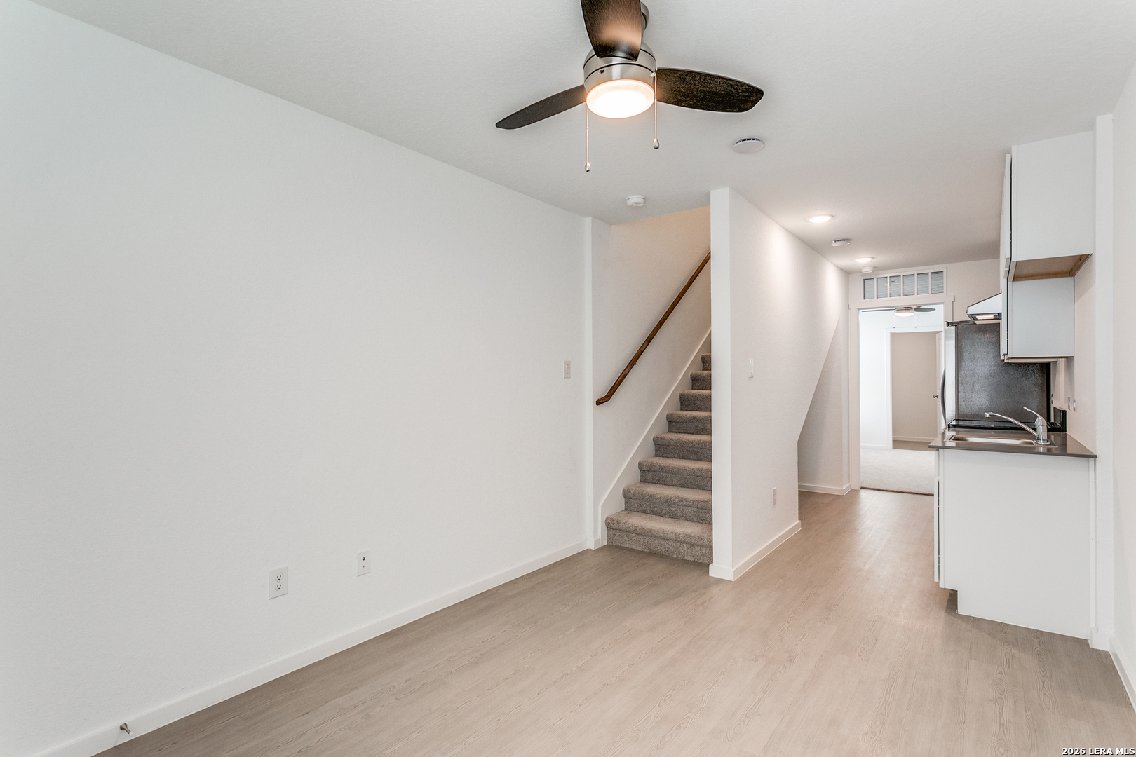 5010 Primrose Converse, TX 78109 - Photo 7 of 24 wooden floor in an empty room with a fireplace