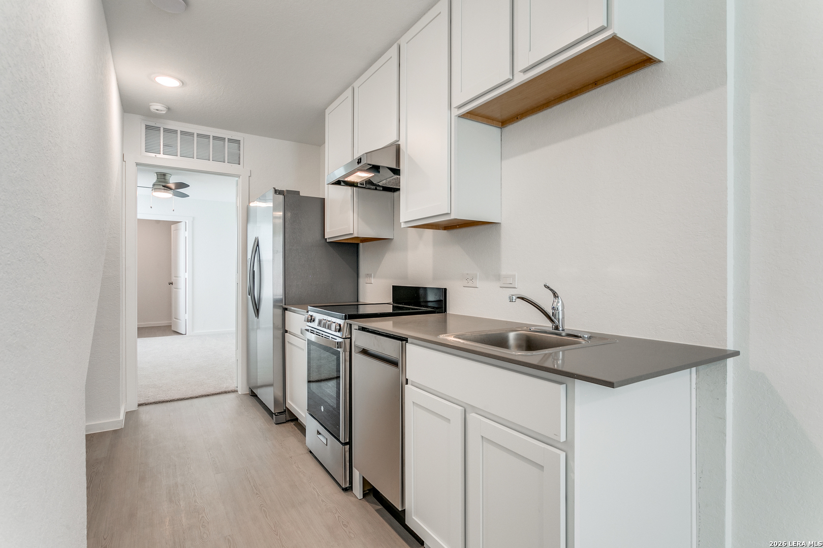 5010 Primrose Converse, TX 78109 - Photo 8 of 24 a kitchen with stainless steel appliances granite countertop a sink a stove and a refrigerator