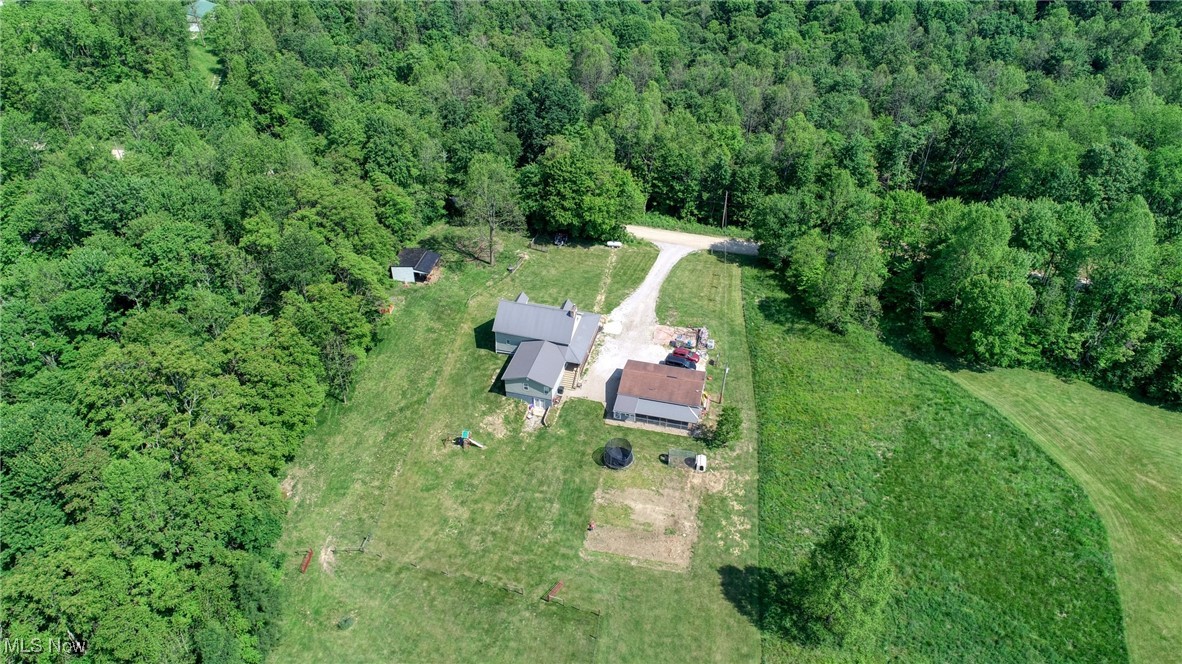 8498 Euga Road Newcomerstown, OH 43832 - Photo 39 of 49 Aerial view of property and surrounding area with a forest