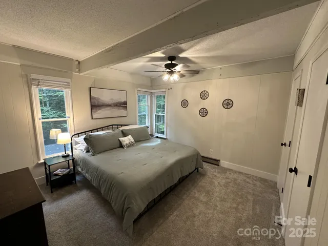 a bedroom with a large bed and a chandelier