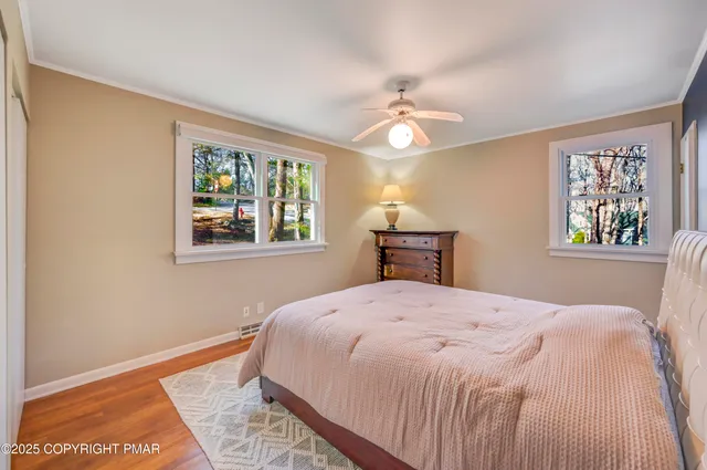 a bedroom with a bed and a painting on the wall