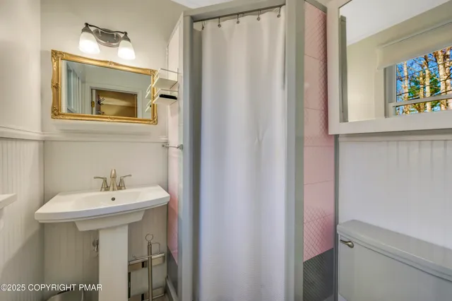 a bathroom with a sink a toilet and bathtub