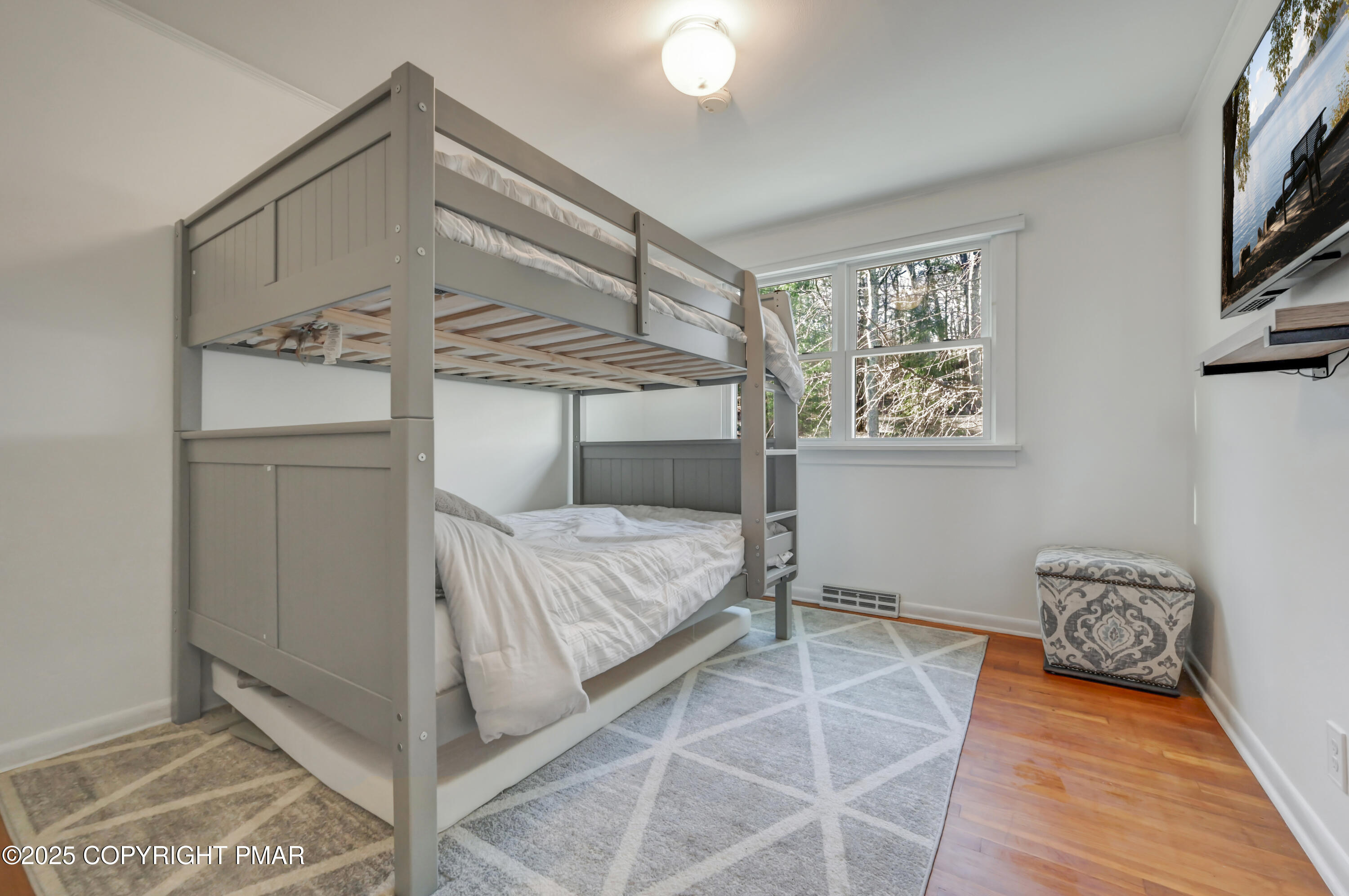 2148 Laurel Lane Cresco, PA 18326 - Photo 24 of 58 a bedroom with a bed and a chandelier