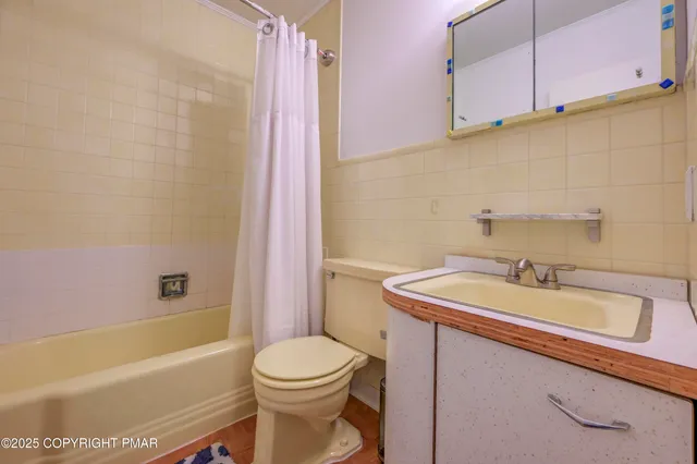 a bathroom with a sink mirror and toilet