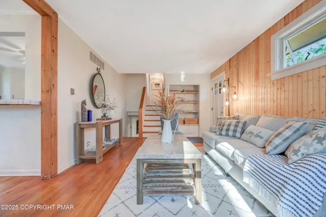 a living room with furniture and wooden floor