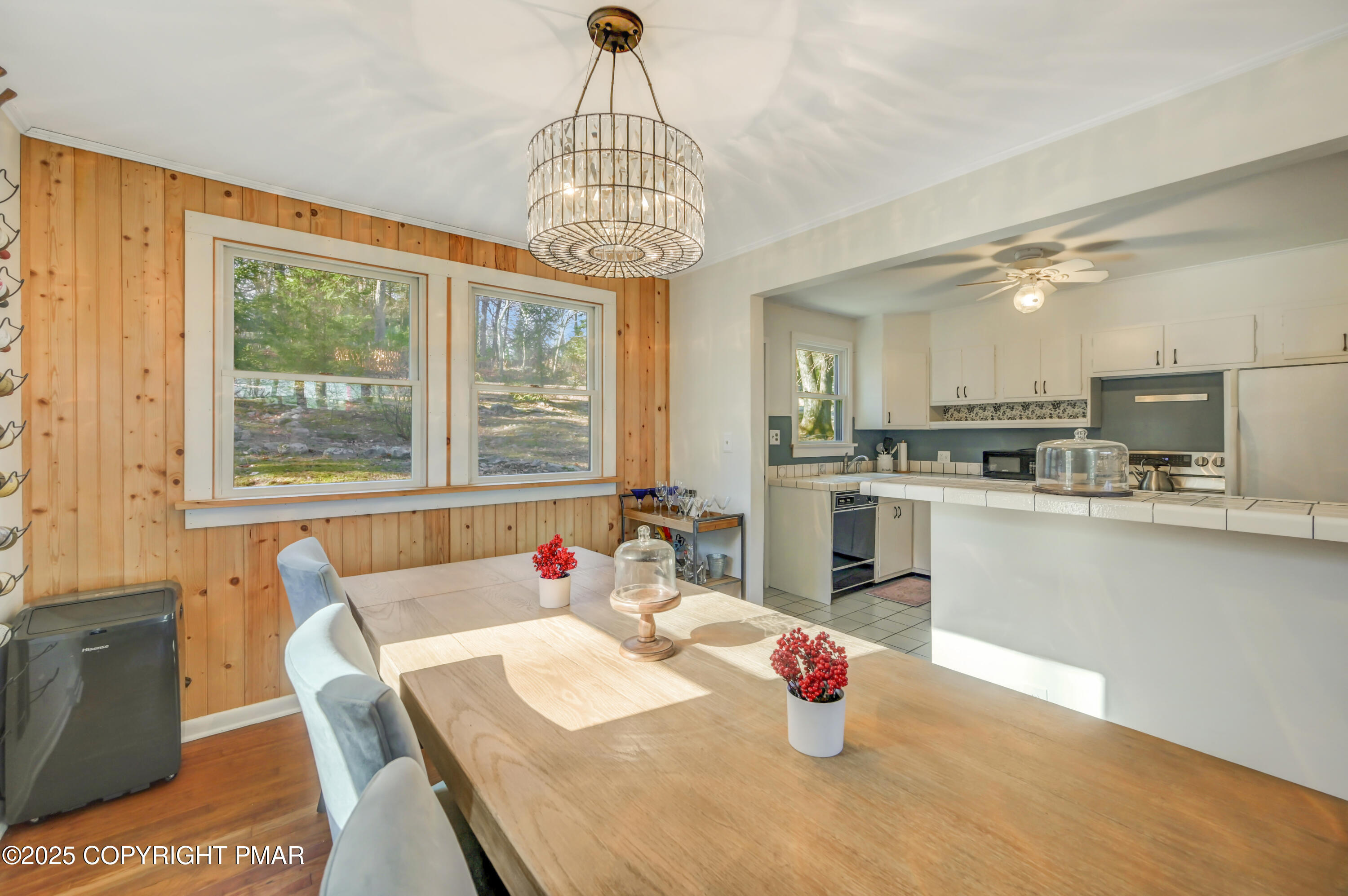 2148 Laurel Lane Cresco, PA 18326 - Photo 10 of 58 a kitchen with a refrigerator a sink dishwasher a dining table and chairs with wooden floor