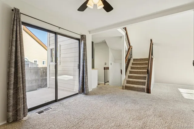 an empty room with fan and windows