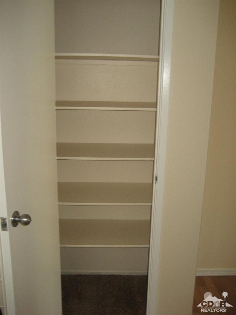 72711 Eagle Road, Unit 4 Palm Desert, CA 92260 - Photo 14 of 29 a view of walk in closet with empty racks