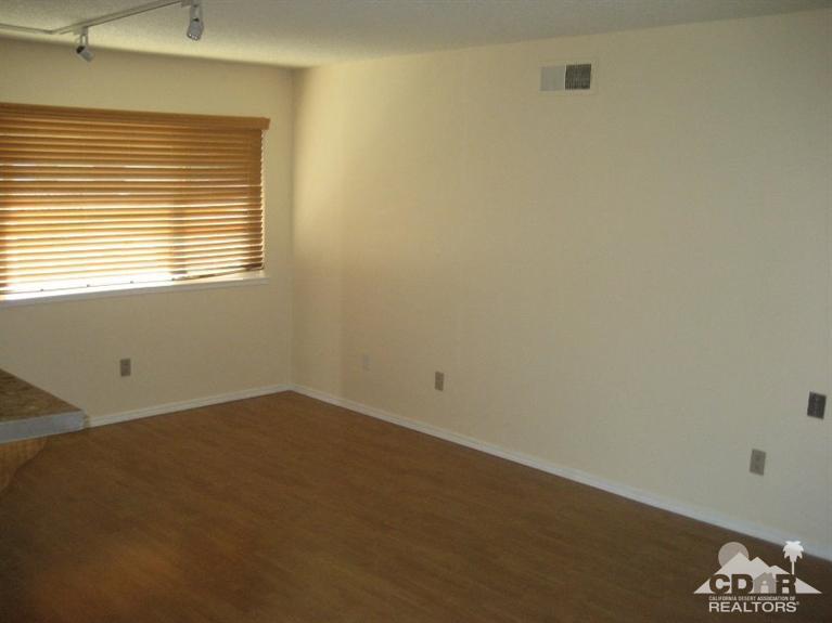 72711 Eagle Road, Unit 4 Palm Desert, CA 92260 - Photo 2 of 29 an empty room with a window
