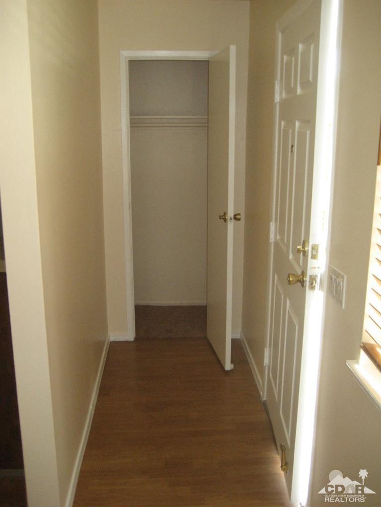 72711 Eagle Road, Unit 4 Palm Desert, CA 92260 - Photo 4 of 29 a view of a hallway with a wooden door