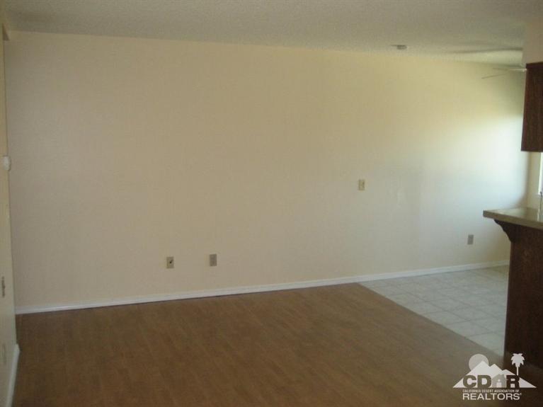 72711 Eagle Road, Unit 4 Palm Desert, CA 92260 - Photo 5 of 29 an empty room with a bench