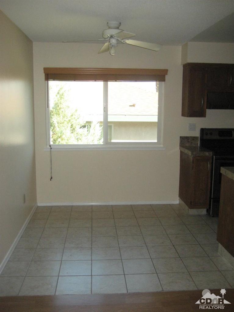 72711 Eagle Road, Unit 4 Palm Desert, CA 92260 - Photo 7 of 29 a view of an empty room and window