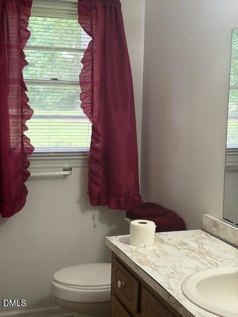 10329 Fanny Brown Road Raleigh, NC 27603 - Photo 7 of 11 a bathroom with a granite countertop toilet and a sink