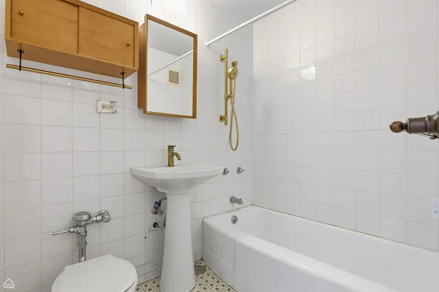 a bathroom with a sink a toilet and bathtub