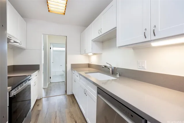 a kitchen with a sink and a refrigerator