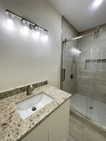 a bathroom with a sink and shower