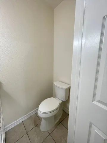a white toilet sitting next to a shower