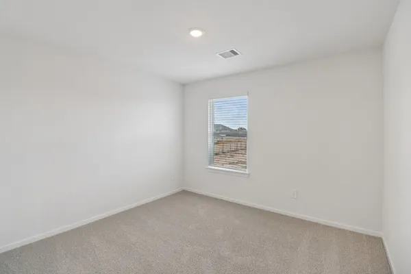 a view of an empty room and closet area