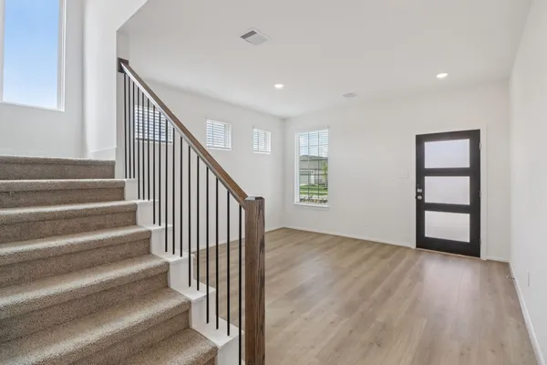 a view of entryway with wooden floor and stairs