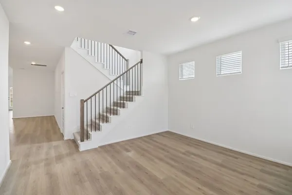 a view of entryway and hall with wooden floor