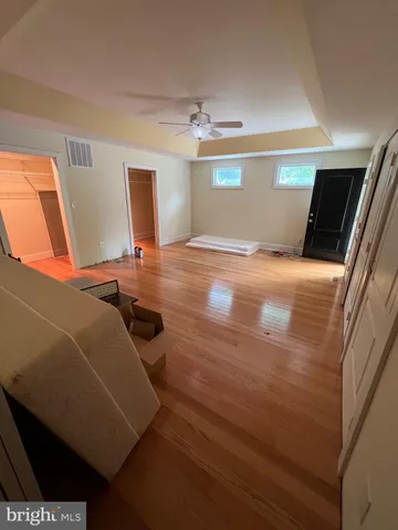 a room with wooden floor and window