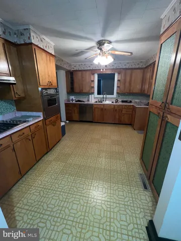 a view of kitchen with furniture and flat screen tv