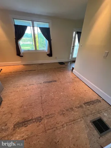 a view of room with window and air conditioner