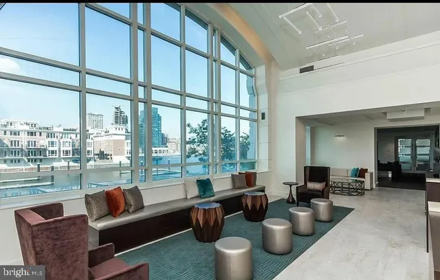 a living room with furniture and a floor to ceiling window