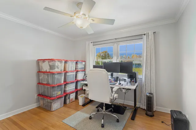 a workspace with furniture window and wooden floor
