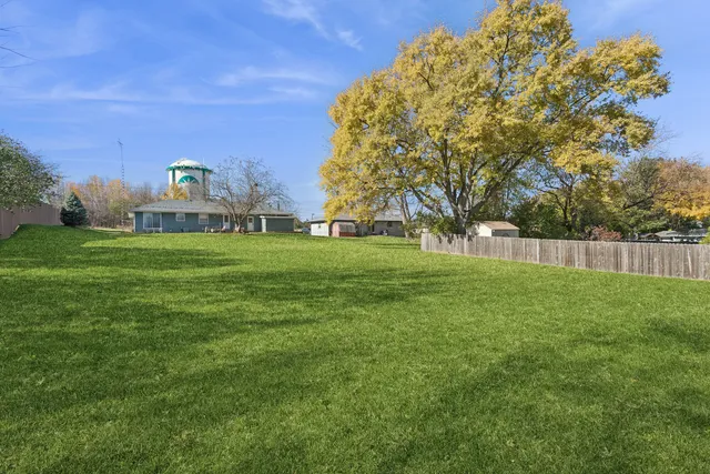 a view of a field of grass and trees