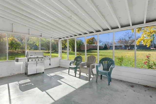 a view of a patio with a table chairs and a backyard
