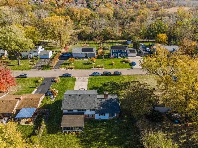 an aerial view of multiple houses with yard