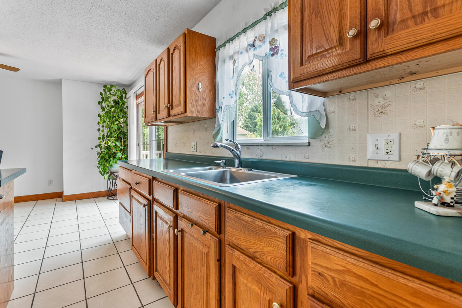 2503 Maplewood Drive Champaign, IL 61821 - Photo 12 of 37 a kitchen with stainless steel appliances a sink dishwasher a refrigerator and wooden cabinets