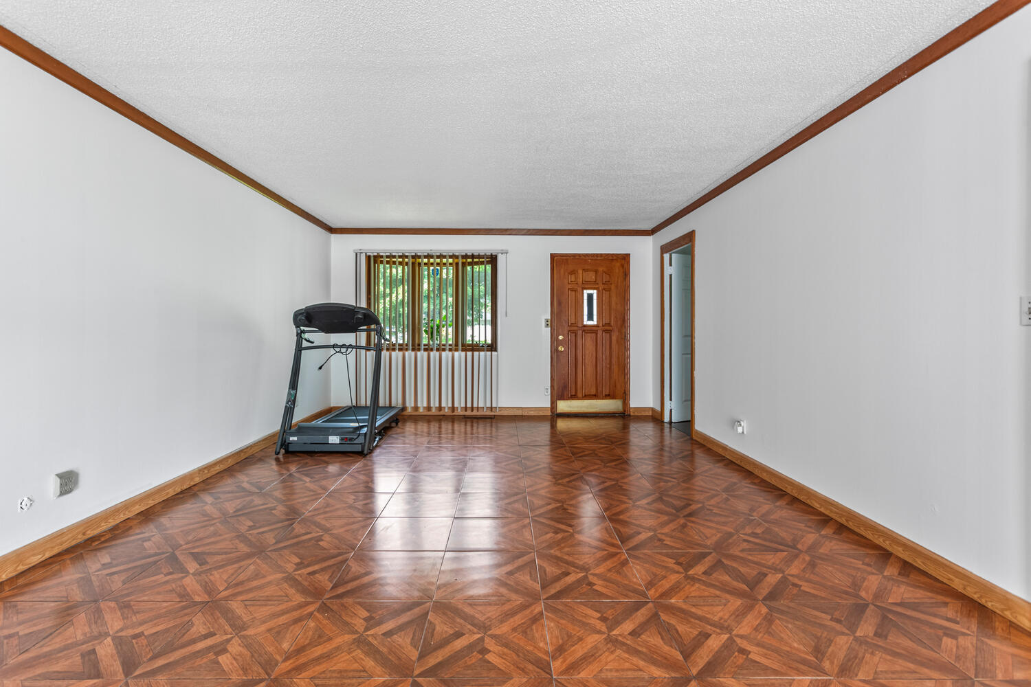 2503 Maplewood Drive Champaign, IL 61821 - Photo 6 of 37 a view of an empty room with a window and wooden floor