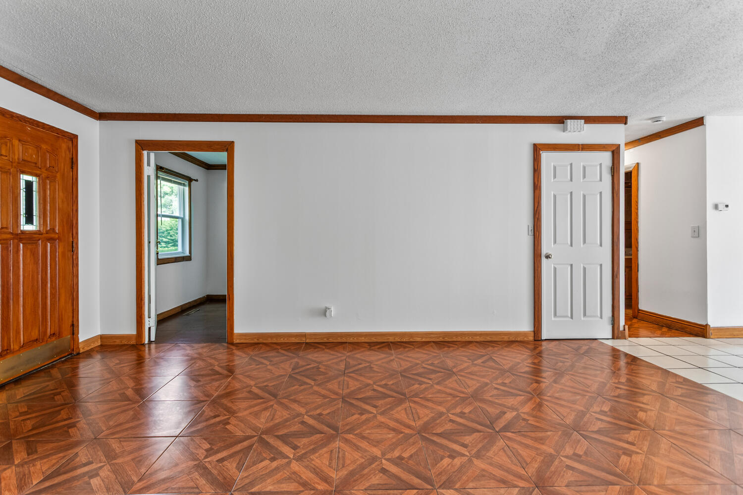 2503 Maplewood Drive Champaign, IL 61821 - Photo 7 of 37 a view of an empty room with wooden floor and a window