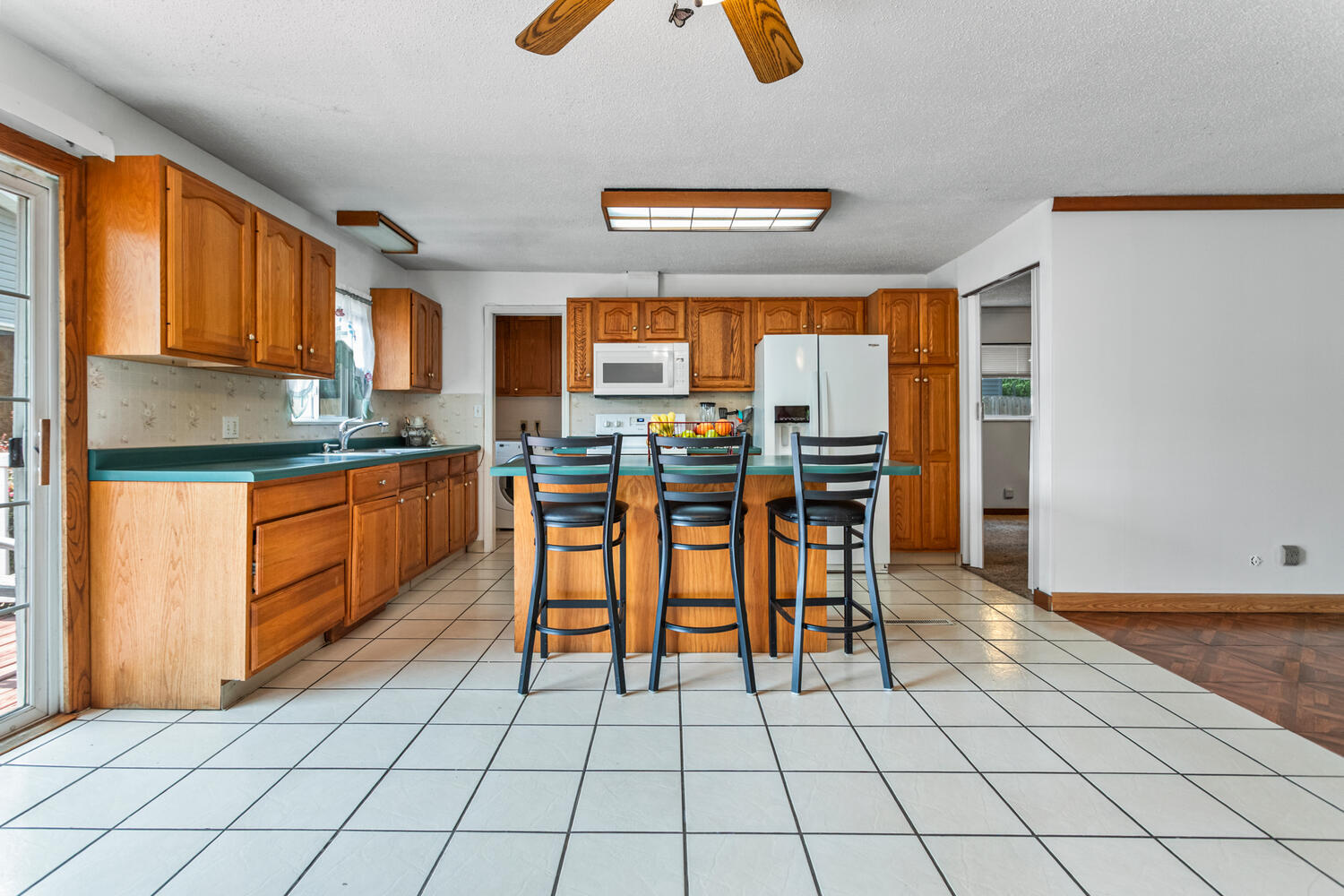 2503 Maplewood Drive Champaign, IL 61821 - Photo 9 of 37 a open kitchen with stainless steel appliances granite countertop a stove top oven a dining table and chairs with wooden floor