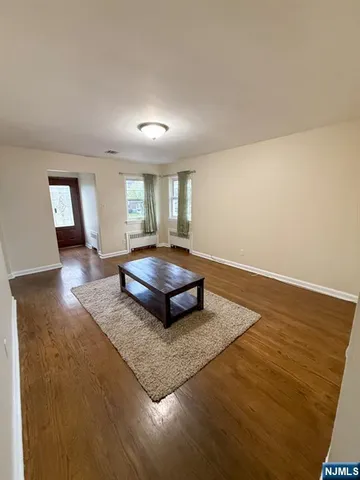 a living room with couch and a view of kitchen