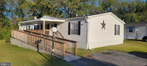 a view of a house with wooden fence