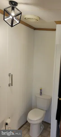 a white toilet sitting next to a shower