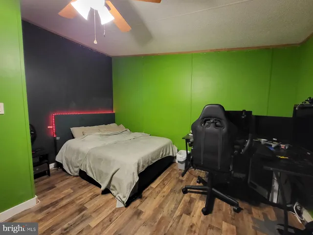 a bed sitting in a room next to a lamp