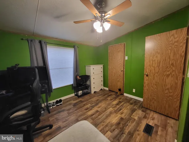 a bedroom with a bed and a mirror