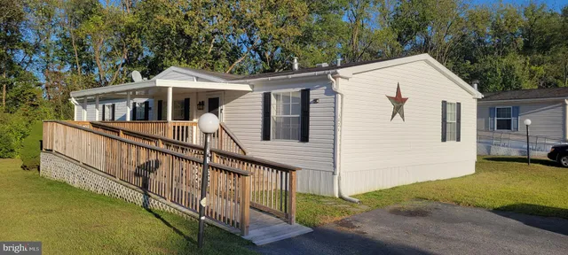 a view of a house with pool and garden