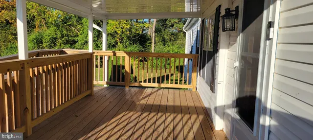 a view of a balcony with wooden floor