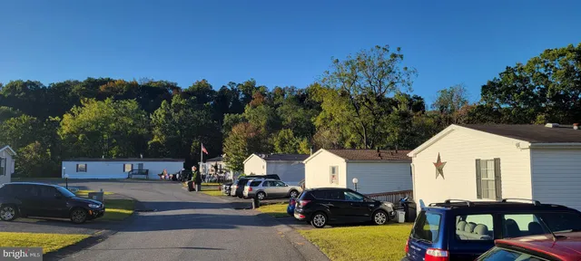 a view of a white house with swimming pool and sitting area