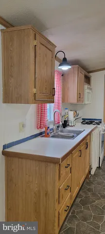 a kitchen with stainless steel appliances a sink and a refrigerator
