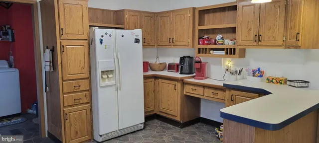 a kitchen with refrigerator and cabinets